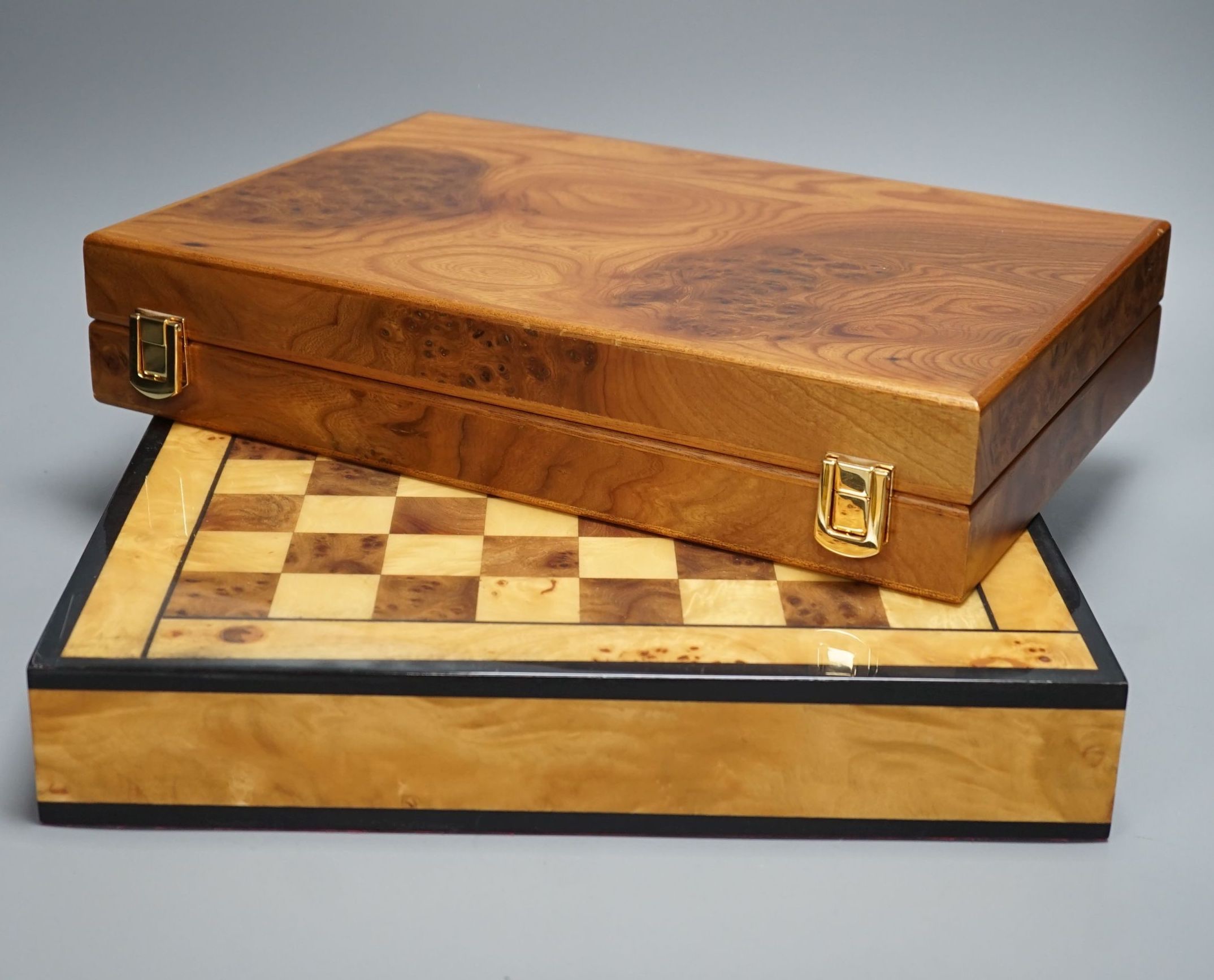 A cased Backgammon set and a chess set with chess-board top and drawers for chess pieces, chess box 35.5 cms x 35.5 cms.
